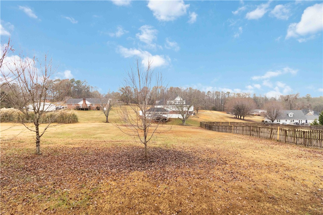 215 Ridge Bay Court Greenville, SC 29611 - Photo 31 of 35 Expansive green spaces and distant residences define this tranquil landscape.