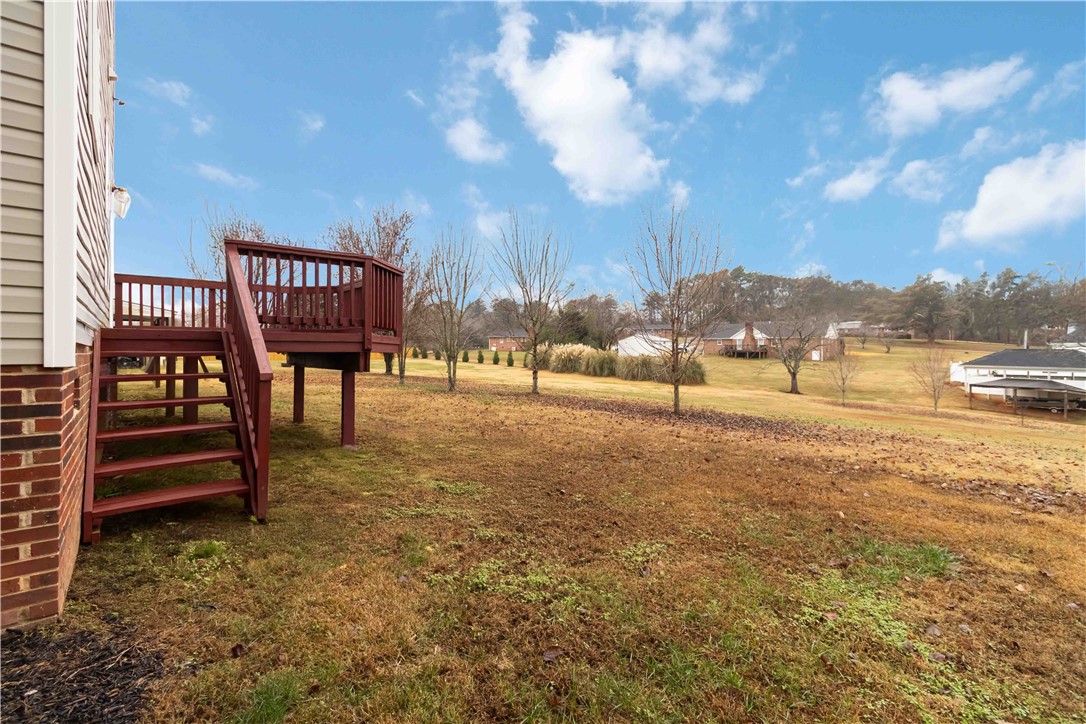 215 Ridge Bay Court Greenville, SC 29611 - Photo 35 of 35 This spacious backyard features a welcoming deck, perfect for outdoor enjoyment and scenic views.