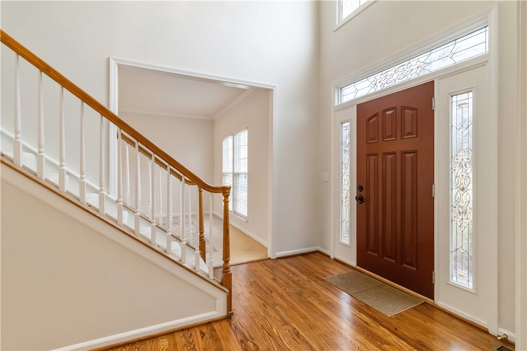 215 Ridge Bay Court Greenville, SC 29611 - Photo 4 of 35 Enter into a bright foyer with polished hardwood flooring and an elegant staircase.