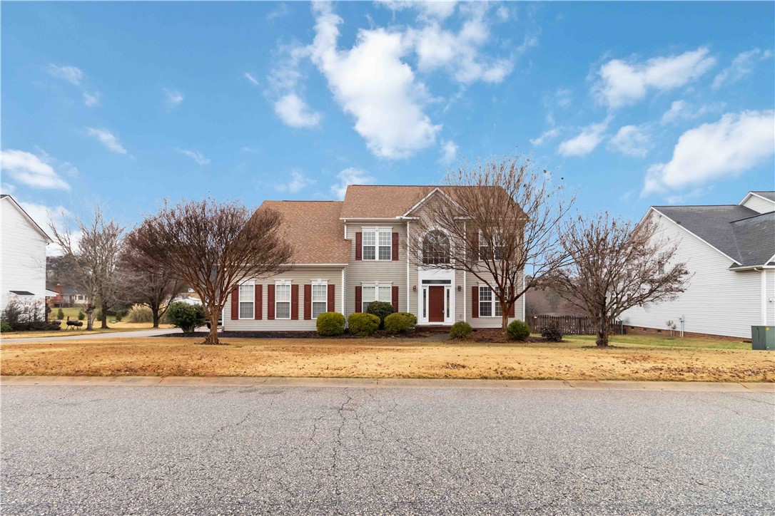 215 Ridge Bay Court Greenville, SC 29611 - Photo 5 of 35 A classic facade with shuttered windows and an arched entryway provides a welcoming curb appeal.