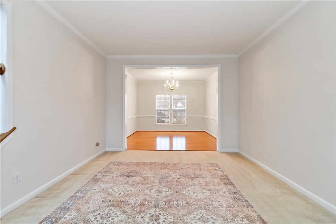 215 Ridge Bay Court Greenville, SC 29611 - Photo 8 of 35 This bright interior space offers a seamless flow between rooms, featuring elegant crown molding and ample natural light.