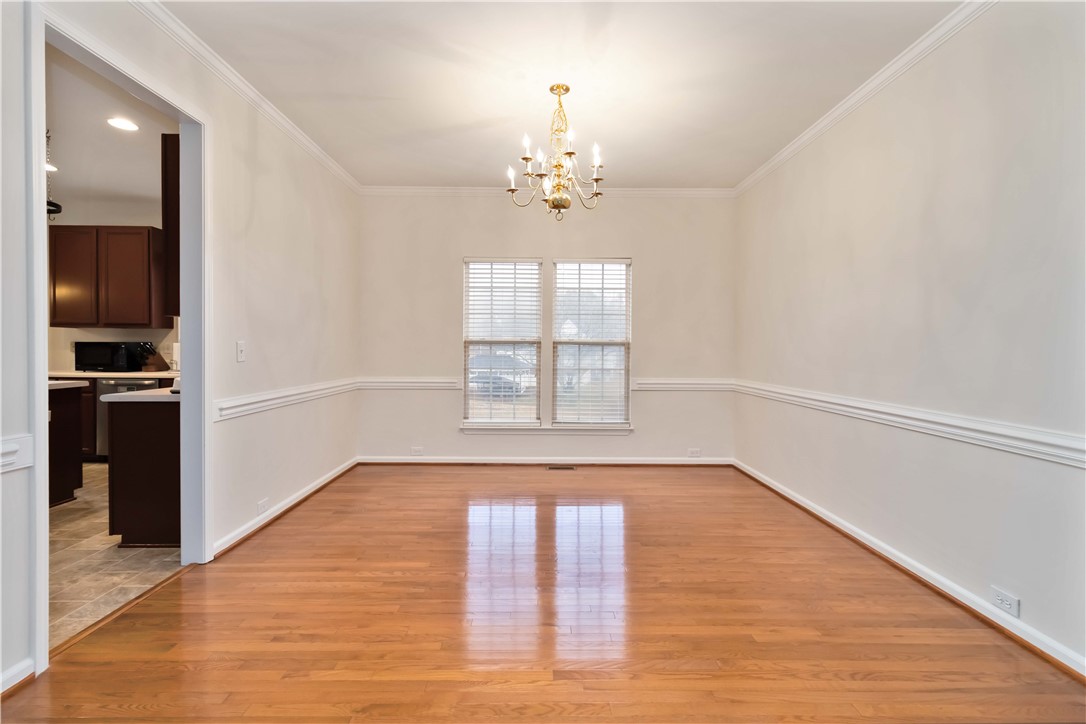 215 Ridge Bay Court Greenville, SC 29611 - Photo 9 of 35 This spacious dining area features gleaming hardwood floors and ample natural light, perfect for gatherings.