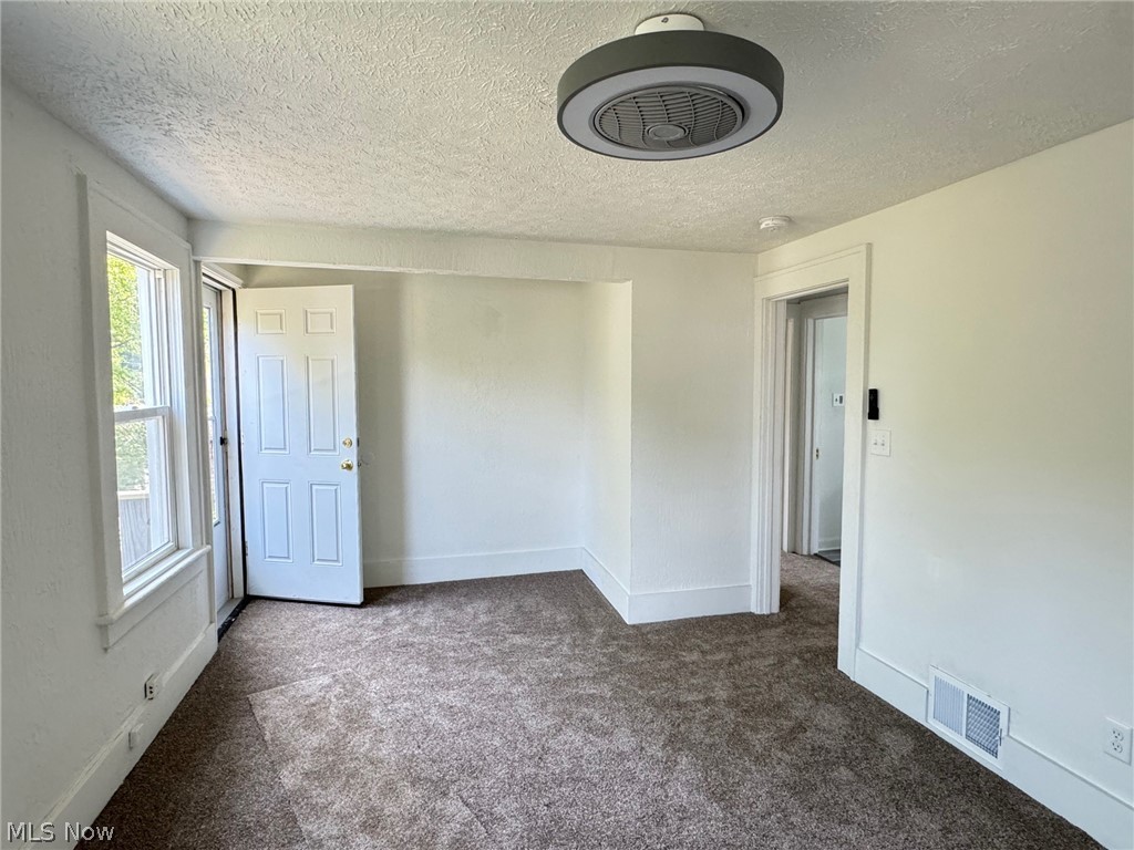 459 Patterson Avenue Akron, OH 44310 - Photo 6 of 24 2nd floor apt. Carpeted empty room featuring a textured ceiling