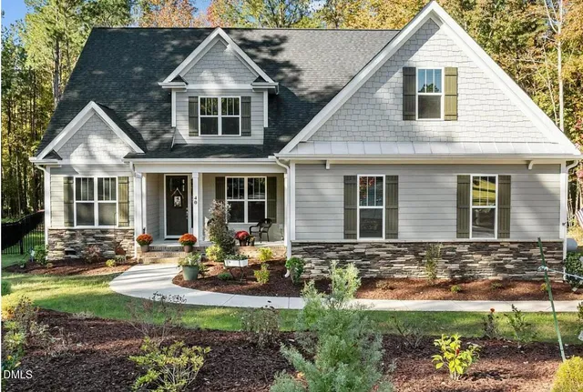 a living room with a fireplace cabinet and a large window