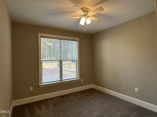 an empty room with a empty space and windows