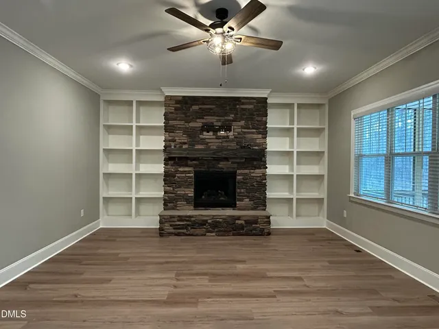 a large kitchen with a large counter top a sink stainless steel appliances and cabinets