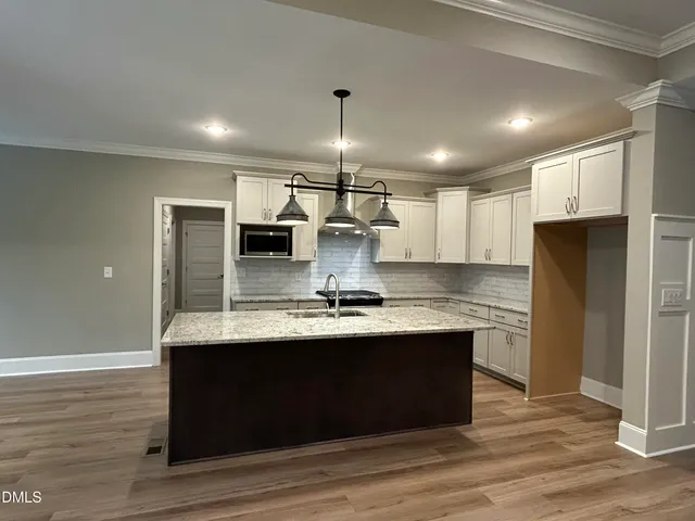a bathroom with a granite countertop sink toilet and mirror
