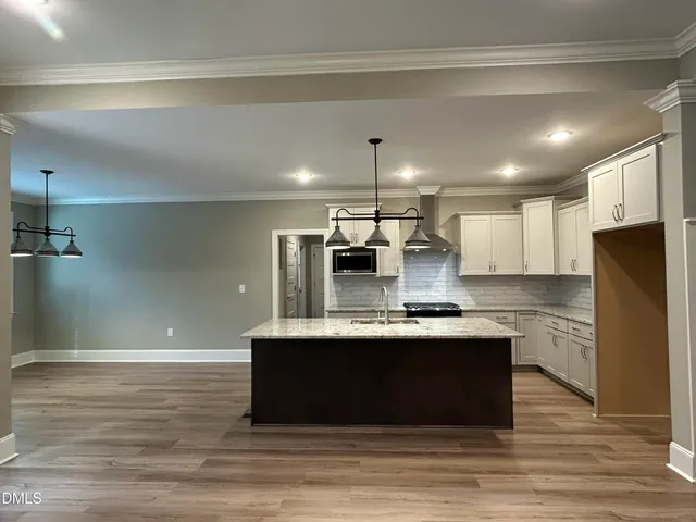 a white bath tub sitting under a bathroom next to a window