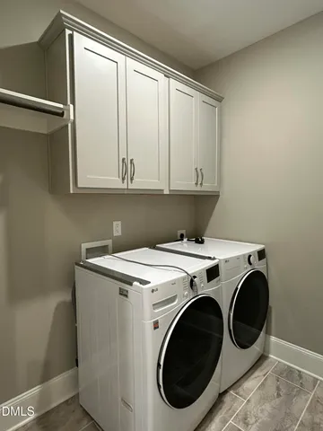 a living room with furniture a flat screen tv and a large window