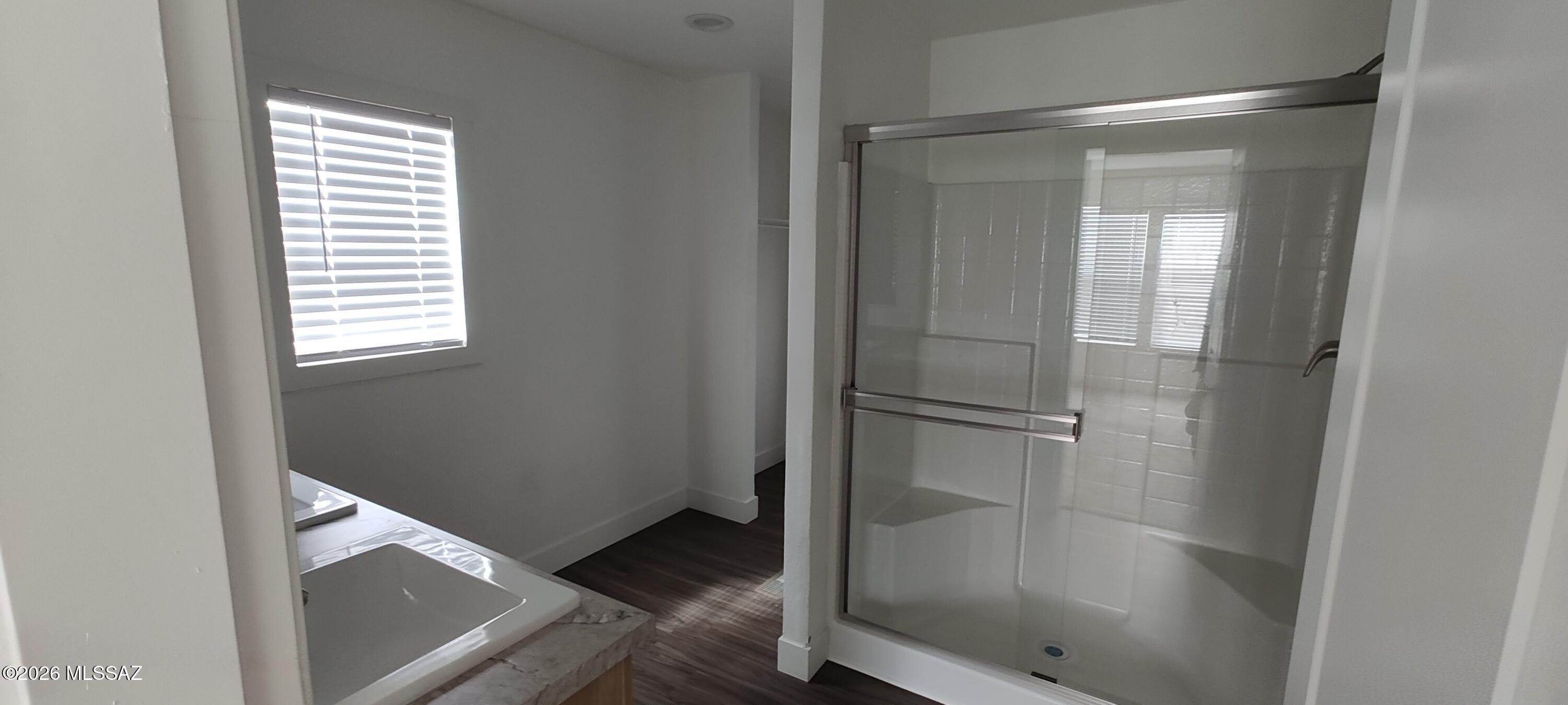 18565 West McClean Road Marana, AZ 85653 - Photo 19 of 37 a bathroom with a glass shower door