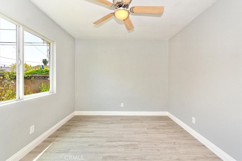 1716 West Piru Street Compton, CA 90222 - Photo 11 of 17 a view of an empty room with window and wooden floor