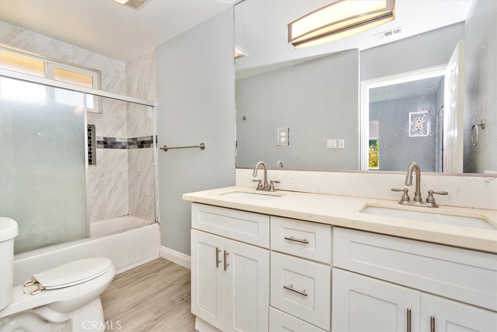 1716 West Piru Street Compton, CA 90222 - Photo 13 of 17 a bathroom with a granite countertop sink toilet and shower