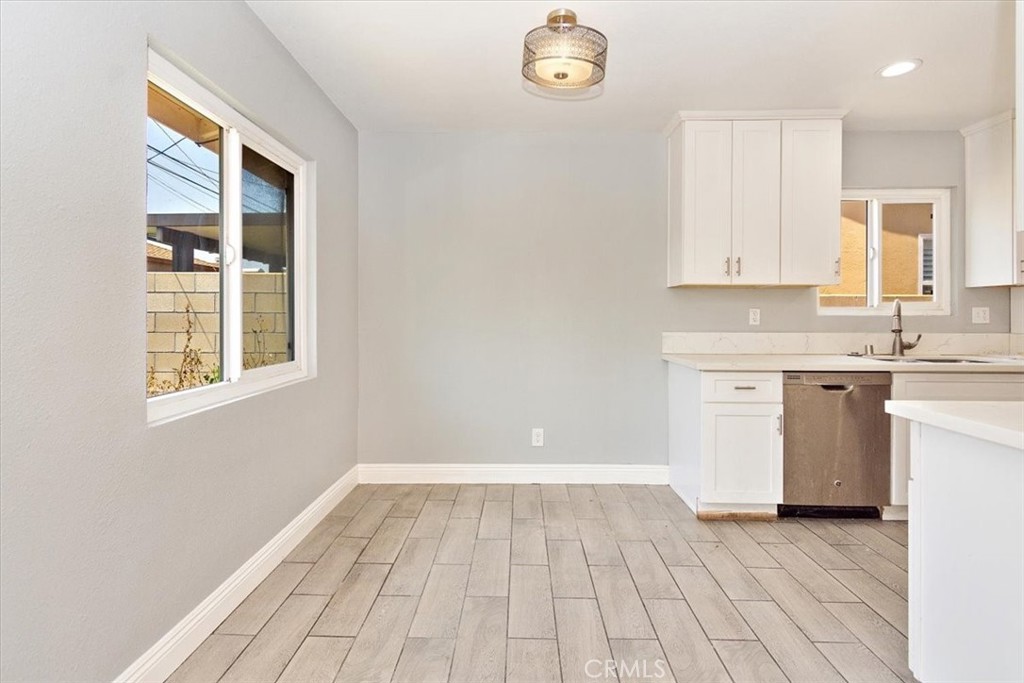 1716 West Piru Street Compton, CA 90222 - Photo 5 of 17 a view of a kitchen with a sink cabinets and wooden floor