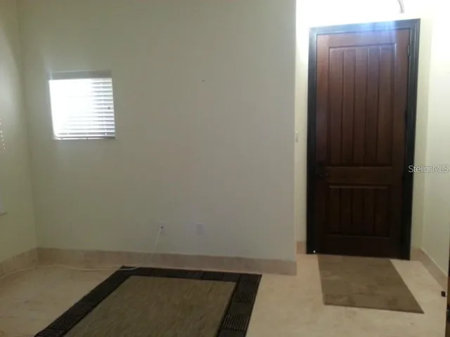 a view of staircase with railing and a window