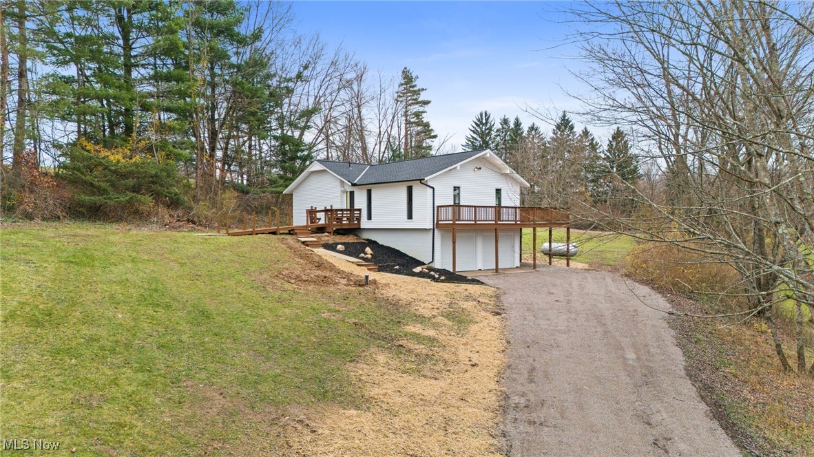 4098 State Road Medina, OH 44256 - Photo 1 of 41 View of side of home with a garage, a deck, and a yard