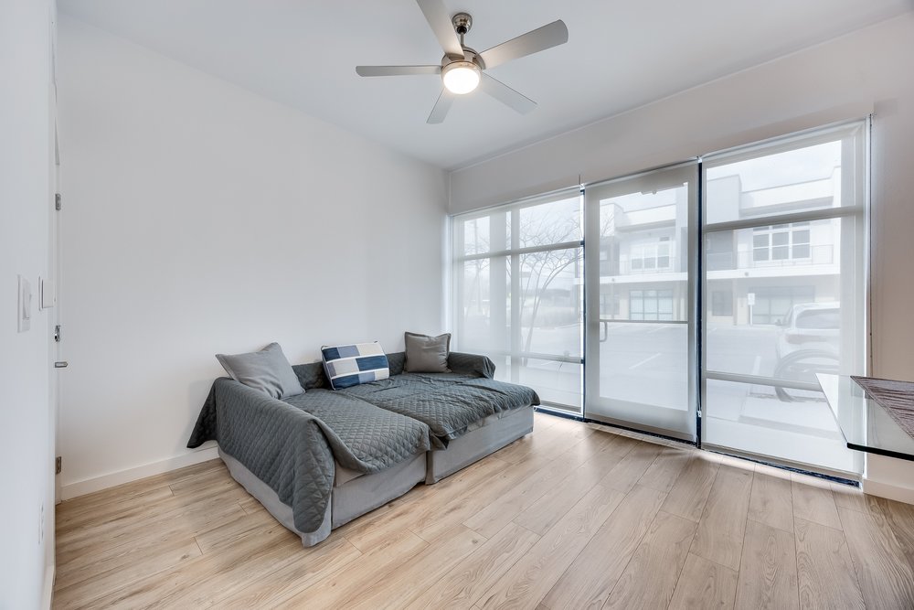 4801 Springdale Road, Unit 2107 Austin, TX 78723 - Photo 17 of 26 a spacious bedroom with a bed and wooden floor