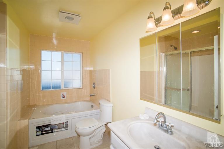 311 West Bard Road Oxnard, CA 93033 - Photo 2 of 10 a bathroom with a sink a toilet and shower