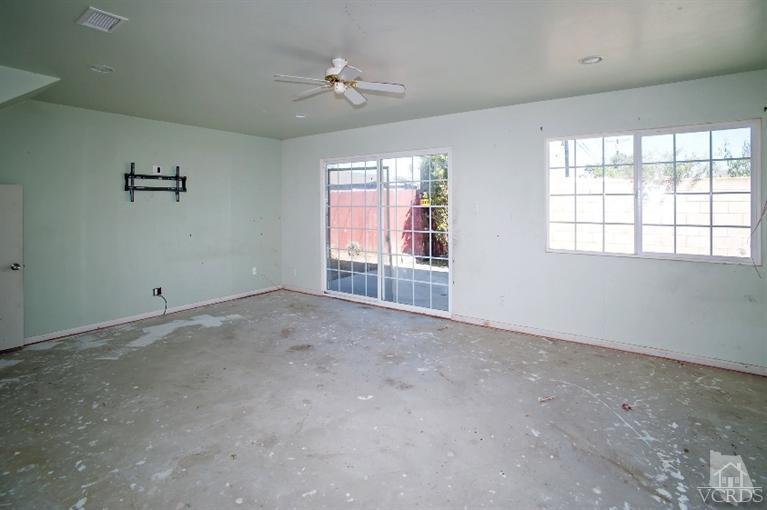 311 West Bard Road Oxnard, CA 93033 - Photo 8 of 10 an empty room with windows and chandelier fan