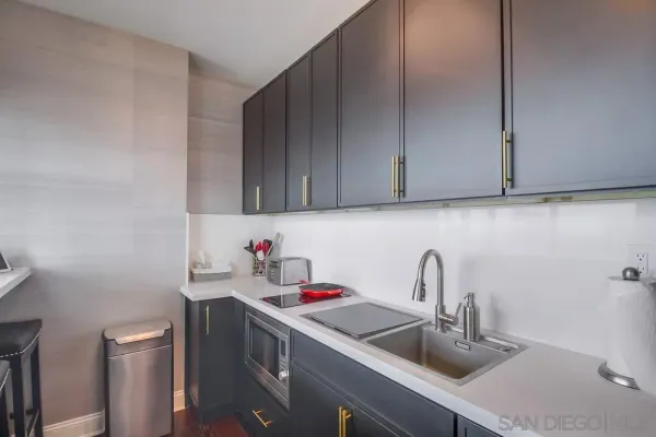 a kitchen with a sink and cabinets