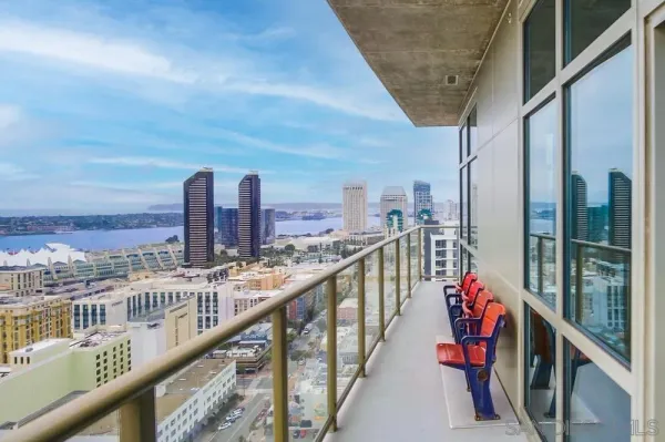 a view of a livingroom with wooden floor and a ceiling fan