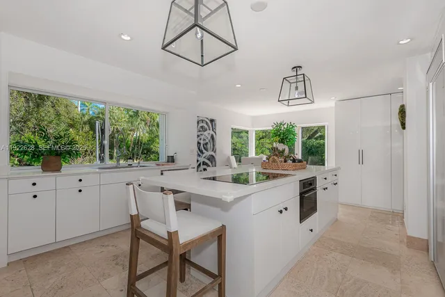 a large bedroom with bed tv and window
