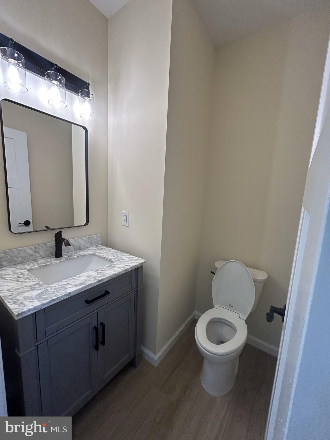 1178 South Spring Road Vineland, NJ 08361 - Photo 15 of 45 a bathroom with a granite countertop toilet sink and mirror