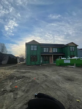 a view of a big house with a big yard and large trees