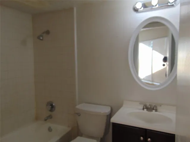 a bathroom with a sink toilet and a mirror