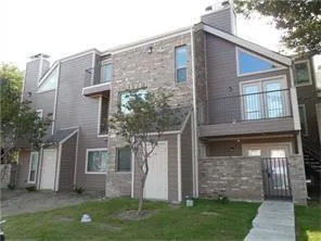 a brick building with a yard