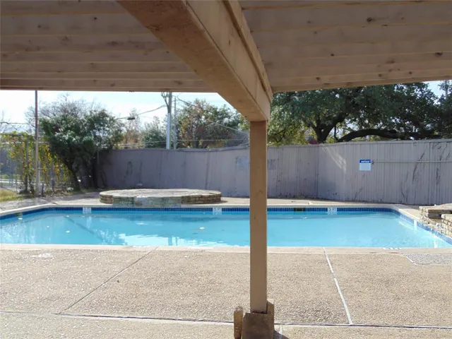 a view of a swimming pool with a patio