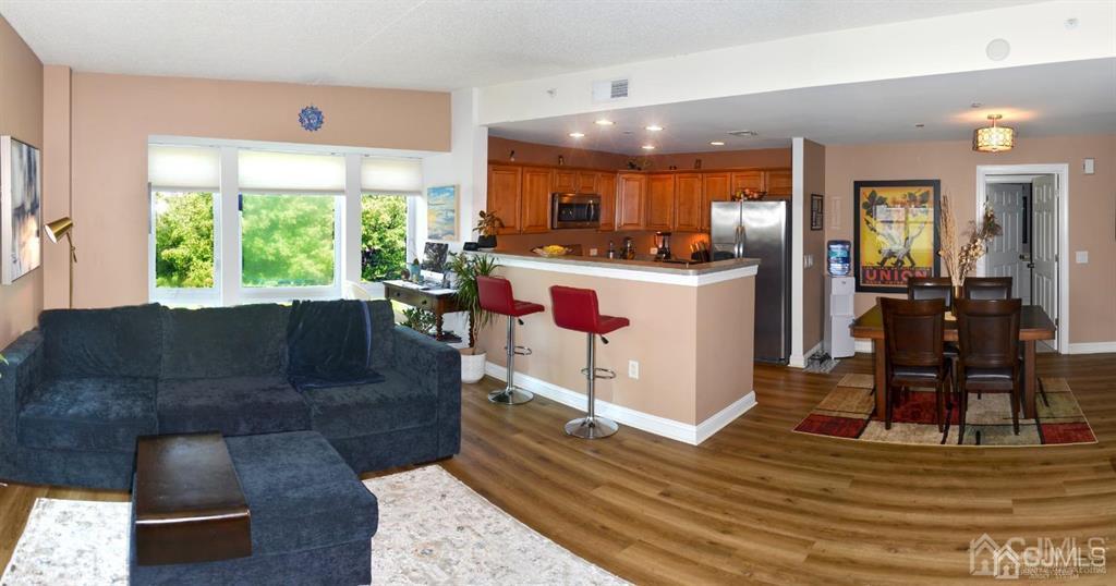 358 Rector Street, Unit 502 Perth Amboy, NJ 08861 - Photo 3 of 13 a living room with kitchen island granite countertop furniture and a large window