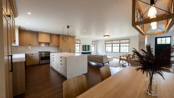 a living room with furniture a flat screen tv and a large window