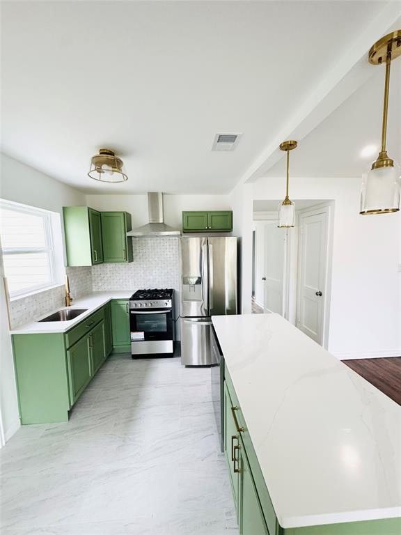 6442 Latta Street Dallas, TX 75227 - Photo 2 of 12 a kitchen with kitchen island a stove a sink dishwasher and a refrigerator with wooden floor