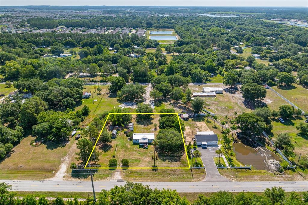 7308 Boyette Road Wesley Chapel, FL 33545 - Photo 2 of 36 an aerial view of residential houses with outdoor space and street view