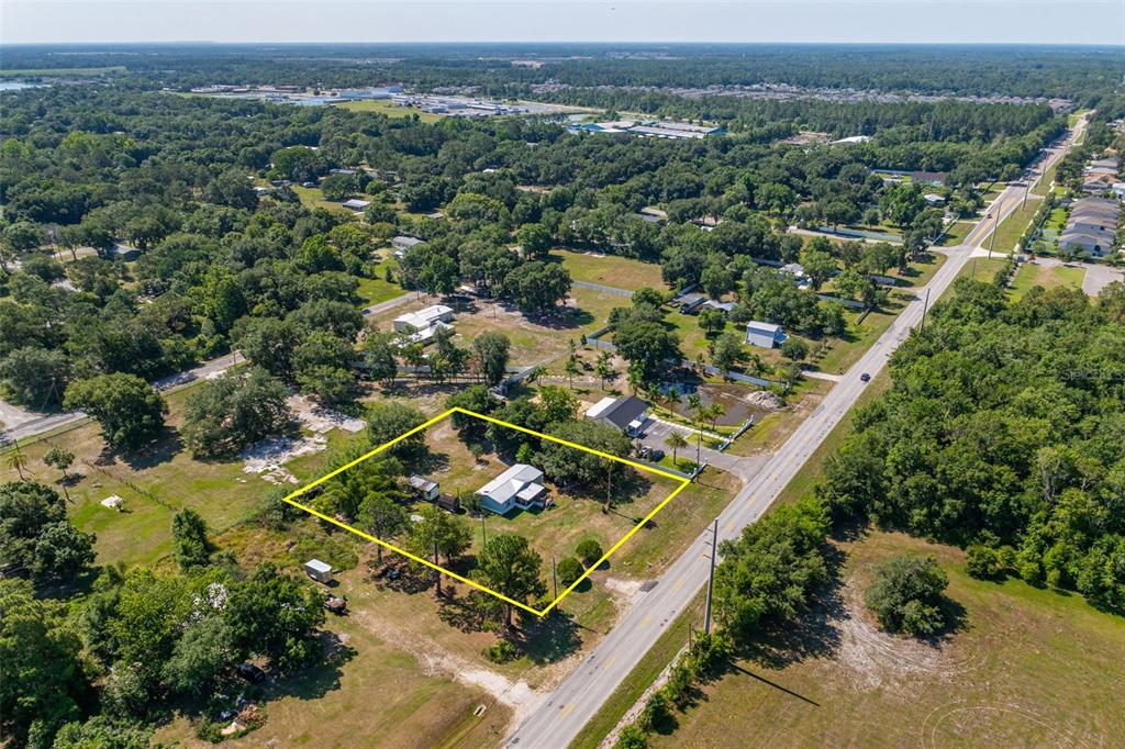 7308 Boyette Road Wesley Chapel, FL 33545 - Photo 22 of 36 an aerial view of a residential houses with outdoor space and trees