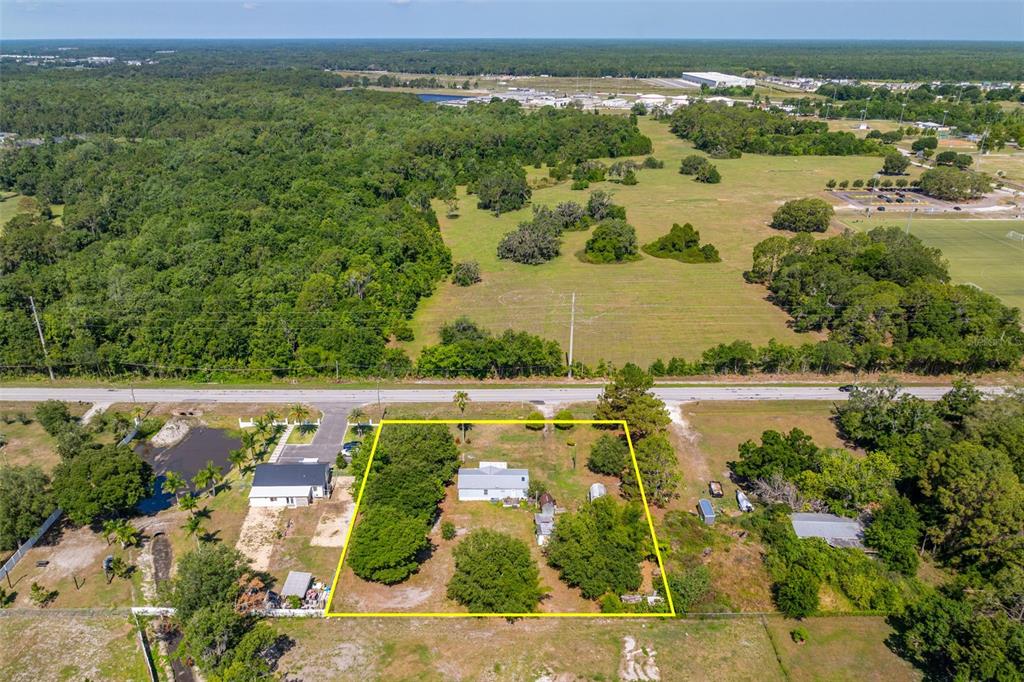 7308 Boyette Road Wesley Chapel, FL 33545 - Photo 25 of 36 an aerial view of lake and residential houses with outdoor space