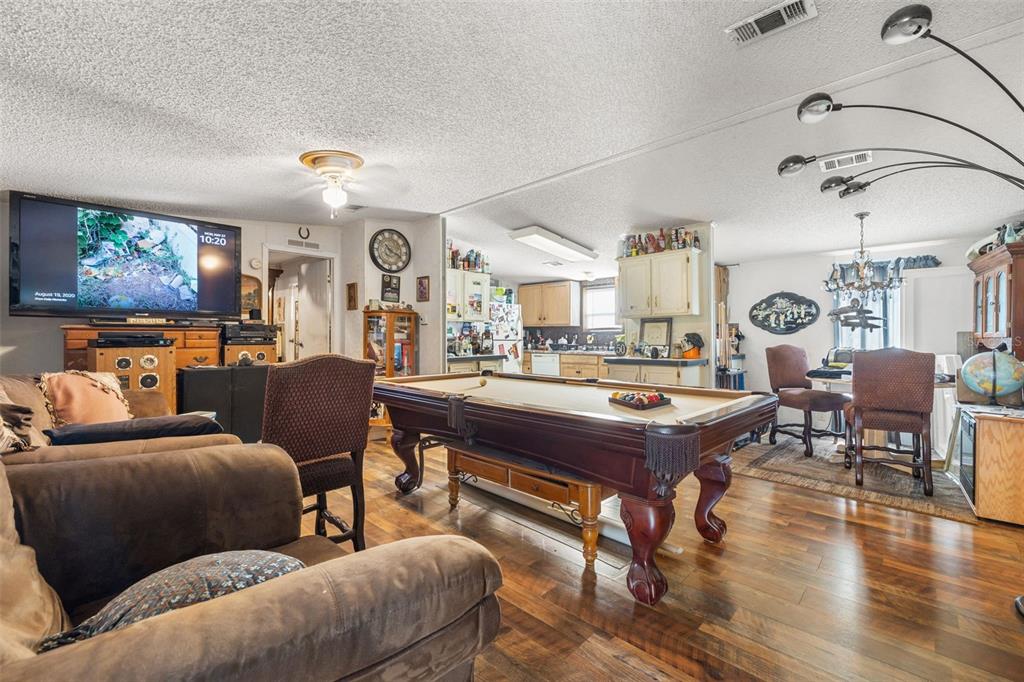 7308 Boyette Road Wesley Chapel, FL 33545 - Photo 30 of 36 a living room with furniture and wooden floor