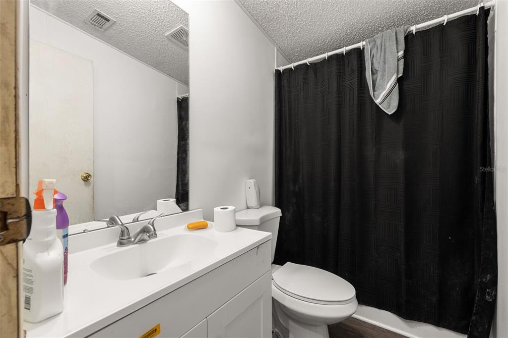 7308 Boyette Road Wesley Chapel, FL 33545 - Photo 32 of 36 a bathroom with a sink vanity mirror and toilet
