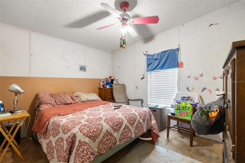 7308 Boyette Road Wesley Chapel, FL 33545 - Photo 33 of 36 a bedroom with a bed and a chandelier