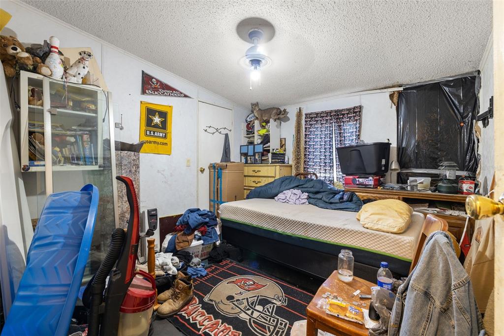 7308 Boyette Road Wesley Chapel, FL 33545 - Photo 34 of 36 a bed room with a bed mirror and a window