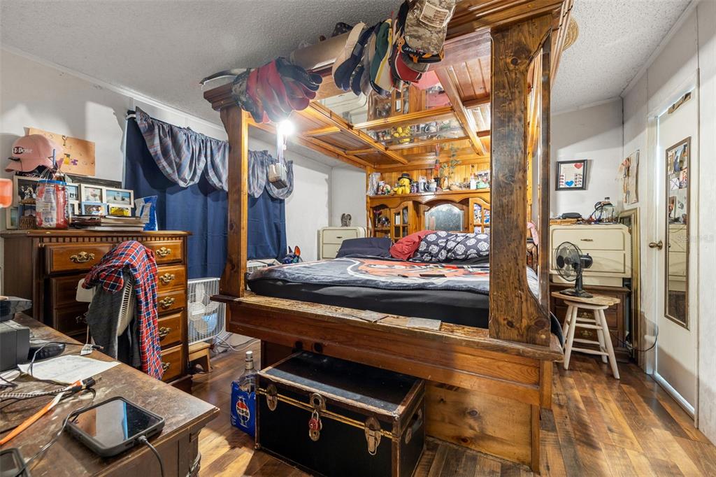 7308 Boyette Road Wesley Chapel, FL 33545 - Photo 35 of 36 a bedroom with furniture and a fireplace