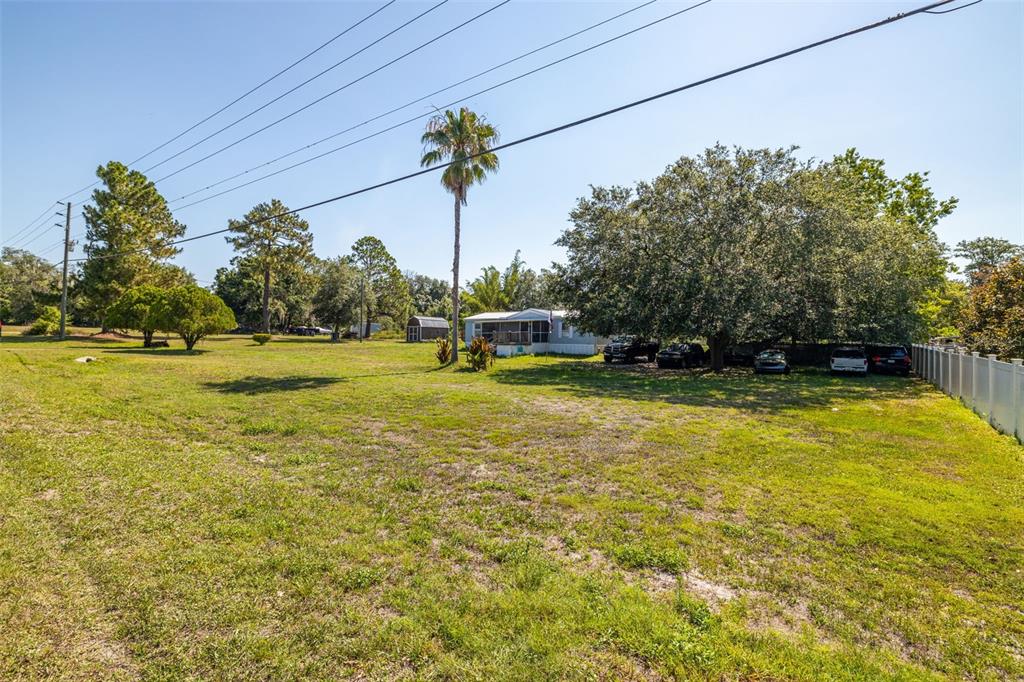 7308 Boyette Road Wesley Chapel, FL 33545 - Photo 9 of 36 a view of a swimming pool with a yard