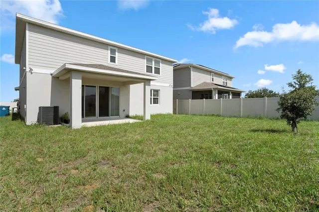a front view of a house with a garden and plants