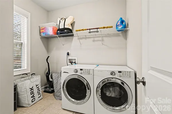a view of washer and dryer with kitchen view