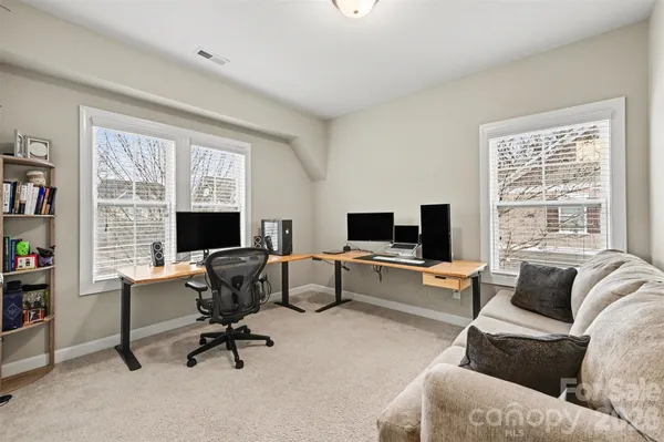 a view of a livingroom with workspace and a window