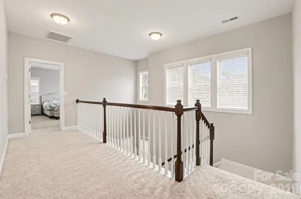 a view of a room with a window and a ceiling fan