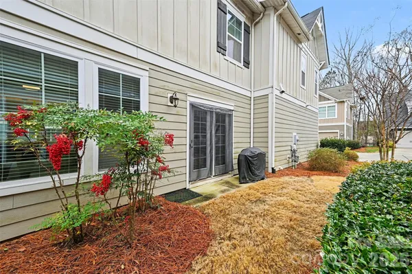 a view of a house with yard and sitting area