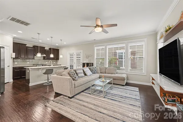 a living room with furniture flat screen tv and large window