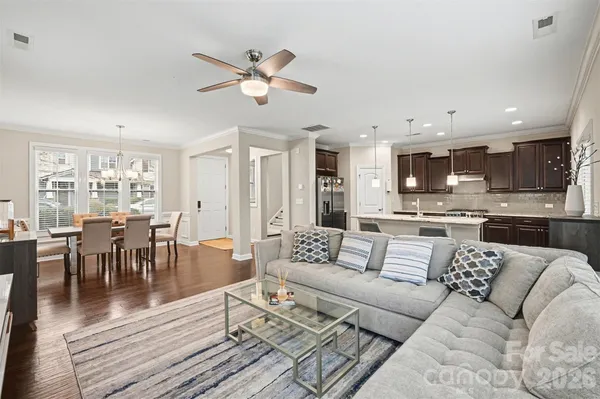 a view of a living room kitchen and a wooden floor
