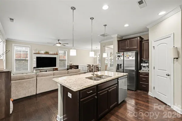 a kitchen with a refrigerator and a sink